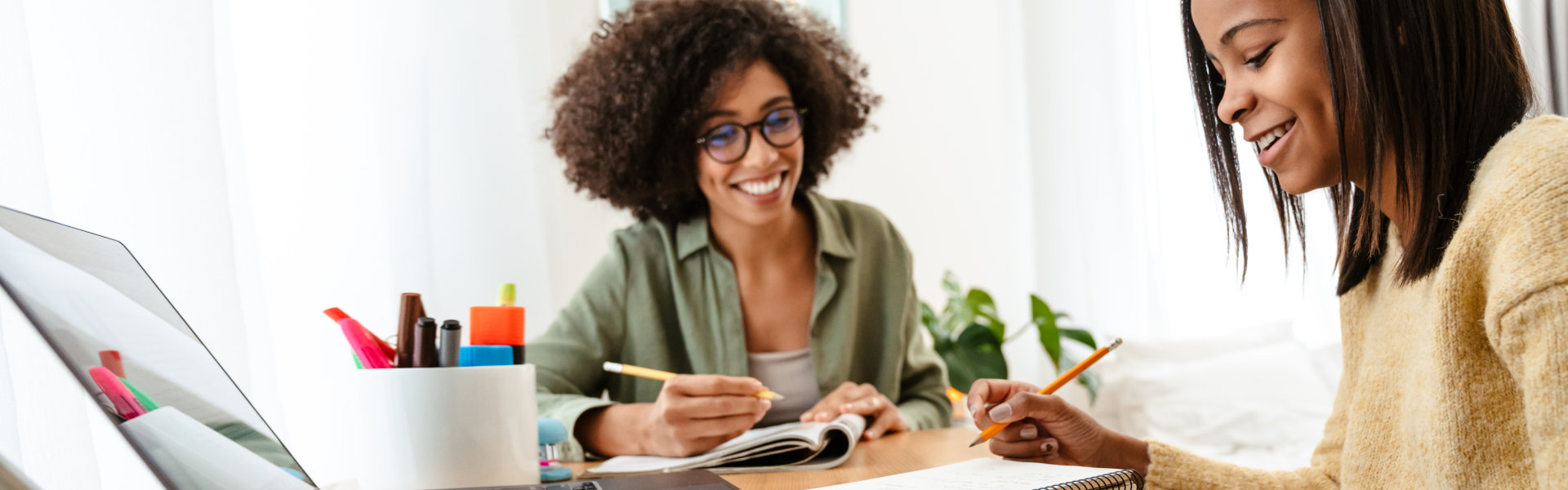 Two Young Women Study Together at Home